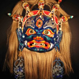 Mahakala (blue), acrylic on paper maché, hand beaded ornaments, horsehair, 14"x16"x4"