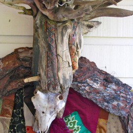 Lord of Divinity - detail (2010), tree bark, tree root, fabric installation, sheep skull, fabric transfer, 34”x55”x17”